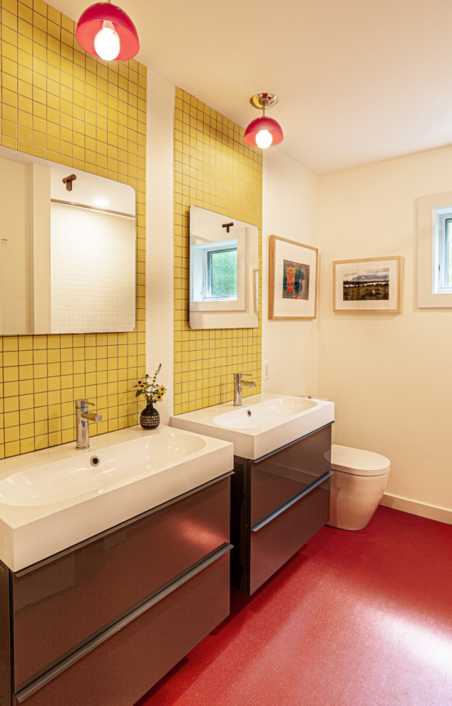 Inspiration for a mid-sized midcentury kids bathroom with flat-panel cabinets, grey cabinets, an alcove tub, a shower/bathtub combo, a one-piece toilet, white tile, ceramic tile, white walls, an integrated sink, solid surface benchtops, red floor, a shower curtain, white benchtops, a double vanity and a floating vanity.