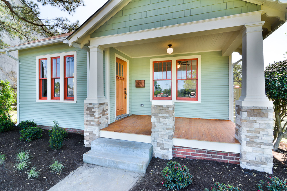 Example of a mid-sized arts and crafts green one-story wood exterior home design in Richmond