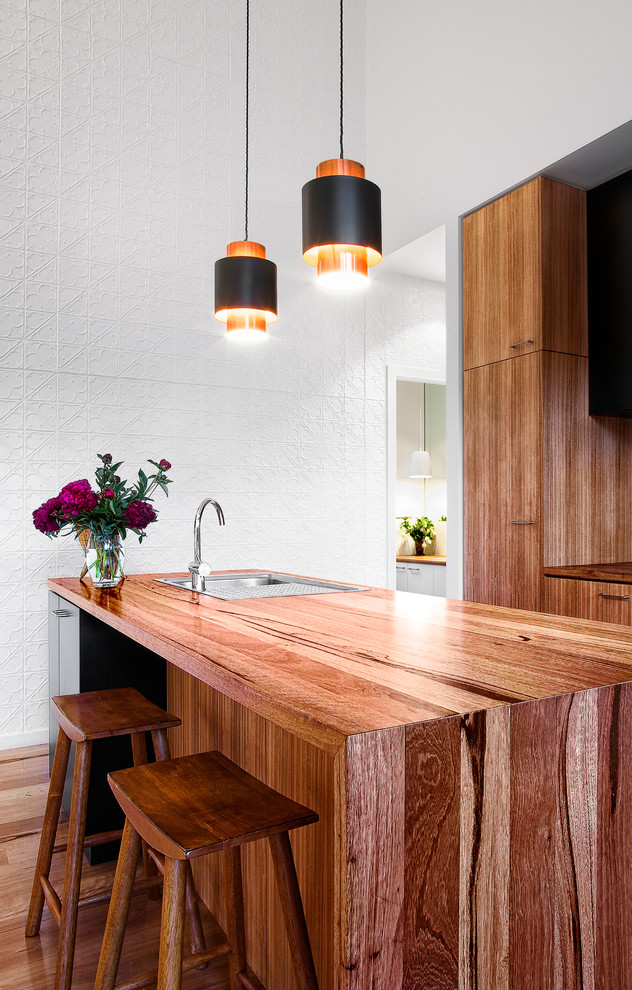 Inspiration for a contemporary eat-in kitchen in Melbourne with a single-bowl sink, flat-panel cabinets, medium wood cabinets, wood benchtops, multi-coloured splashback, medium hardwood floors and with island.