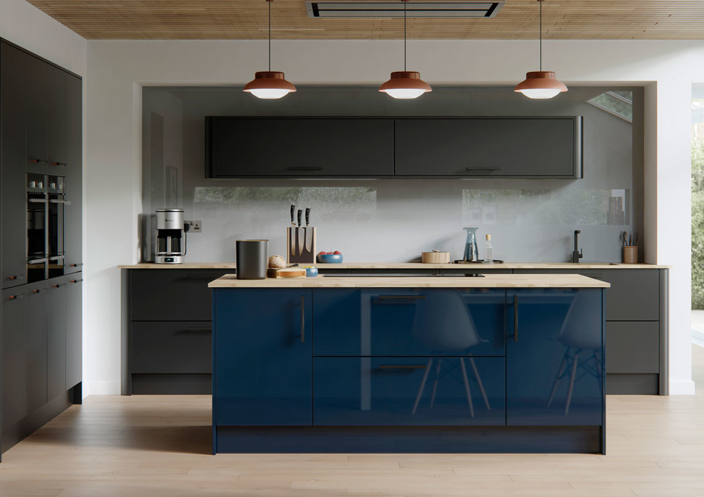 Inspiration for a contemporary l-shaped eat-in kitchen in Manchester with flat-panel cabinets, blue cabinets, wood benchtops, grey splashback, glass sheet splashback, black appliances and with island.