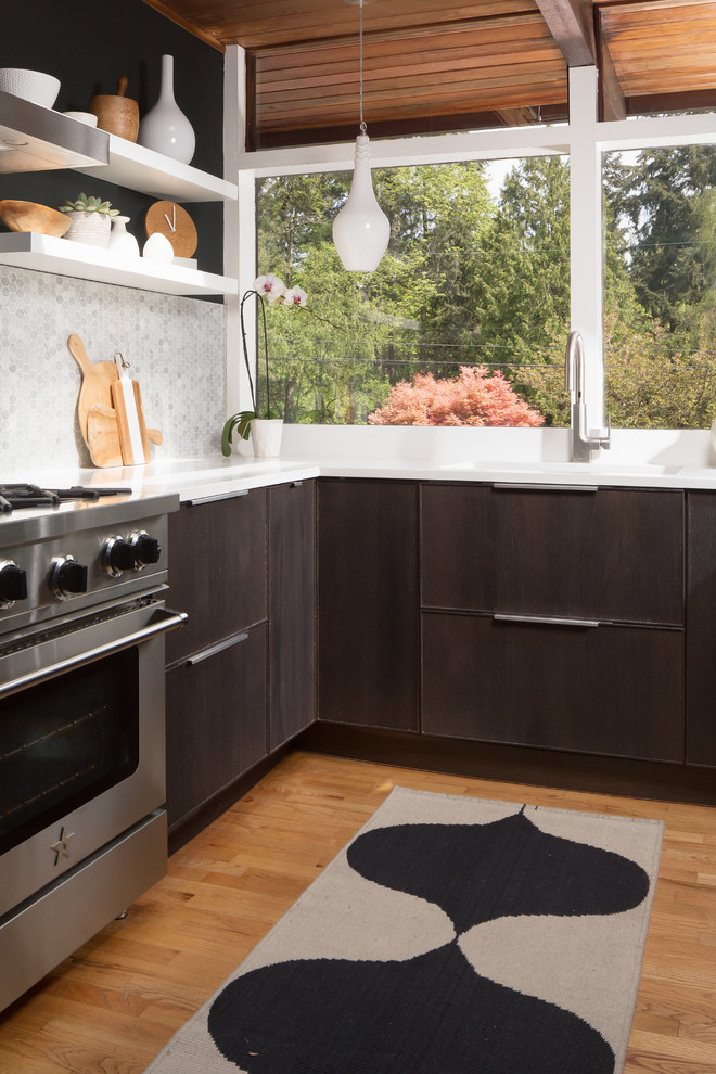 This is an example of a small midcentury galley eat-in kitchen in Seattle with an undermount sink, flat-panel cabinets, dark wood cabinets, marble benchtops, grey splashback, mosaic tile splashback, stainless steel appliances, medium hardwood floors, no island and yellow floor.