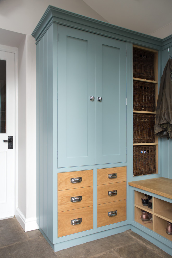 Inspiration for a small traditional l-shaped utility room in Manchester with shaker cabinets, blue cabinets, white walls, limestone floors and grey floor.