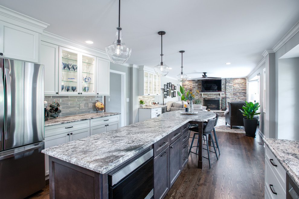 Mid-sized transitional u-shaped dark wood floor and brown floor open concept kitchen photo in Chicago with a double-bowl sink, shaker cabinets, white cabinets, quartz countertops, blue backsplash, porcelain backsplash, stainless steel appliances, an island and gray countertops