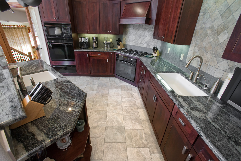Open concept kitchen - large transitional l-shaped porcelain tile open concept kitchen idea in Denver with an island, an undermount sink, shaker cabinets, red cabinets, granite countertops, gray backsplash, stone tile backsplash and black appliances