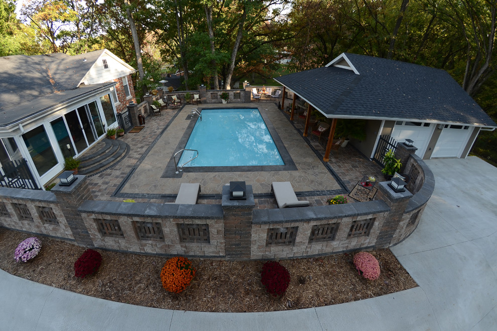 Example of a mountain style backyard concrete paver home design design