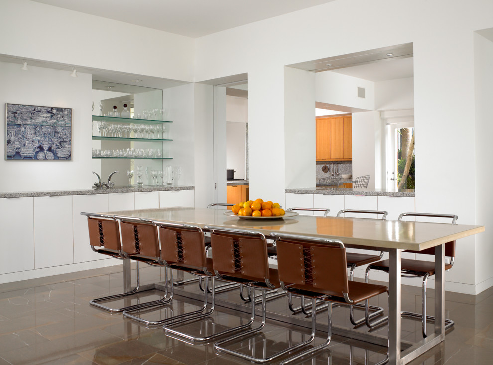 Photo of a contemporary kitchen/dining combo in Miami with white walls.