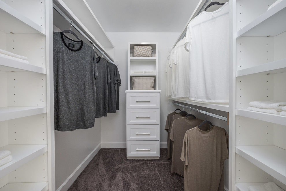 Design ideas for a large modern gender-neutral walk-in wardrobe in Houston with raised-panel cabinets, white cabinets, carpet and grey floor.