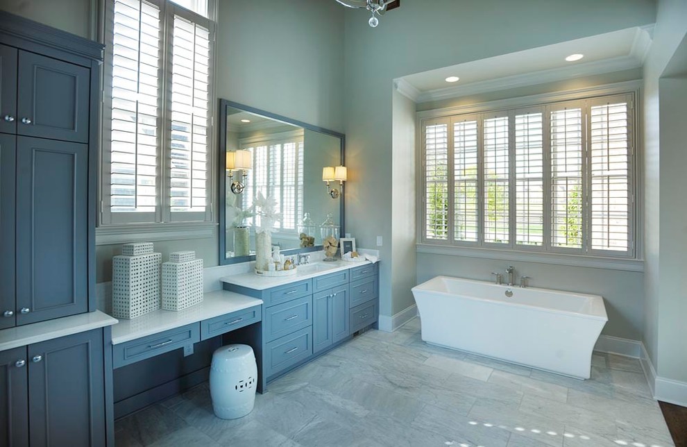 This is an example of a mid-sized country master bathroom in Nashville with flat-panel cabinets, grey cabinets, quartzite benchtops, a freestanding tub, gray tile, grey walls, ceramic floors, stone tile and an undermount sink.