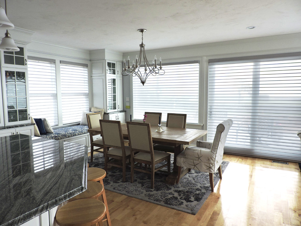 Large beach style light wood floor and beige floor kitchen/dining room combo photo with white walls and no fireplace