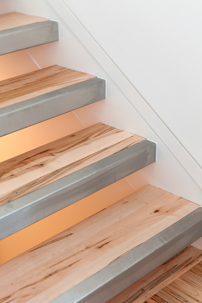 This is an example of a mid-sized modern wood floating staircase in Wilmington.