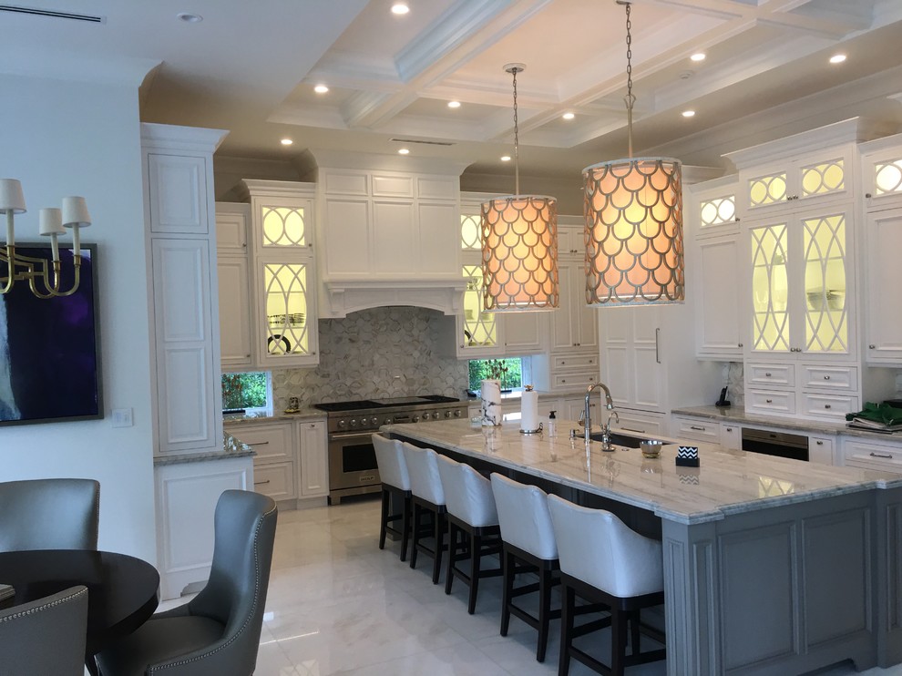 Eat-in kitchen - large transitional u-shaped marble floor and white floor eat-in kitchen idea in Miami with an undermount sink, recessed-panel cabinets, white cabinets, marble countertops, gray backsplash, stone tile backsplash, paneled appliances and an island