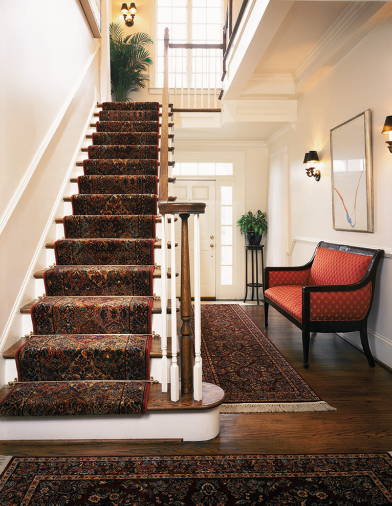 Mid-sized traditional wood straight staircase in St Louis with painted wood risers.