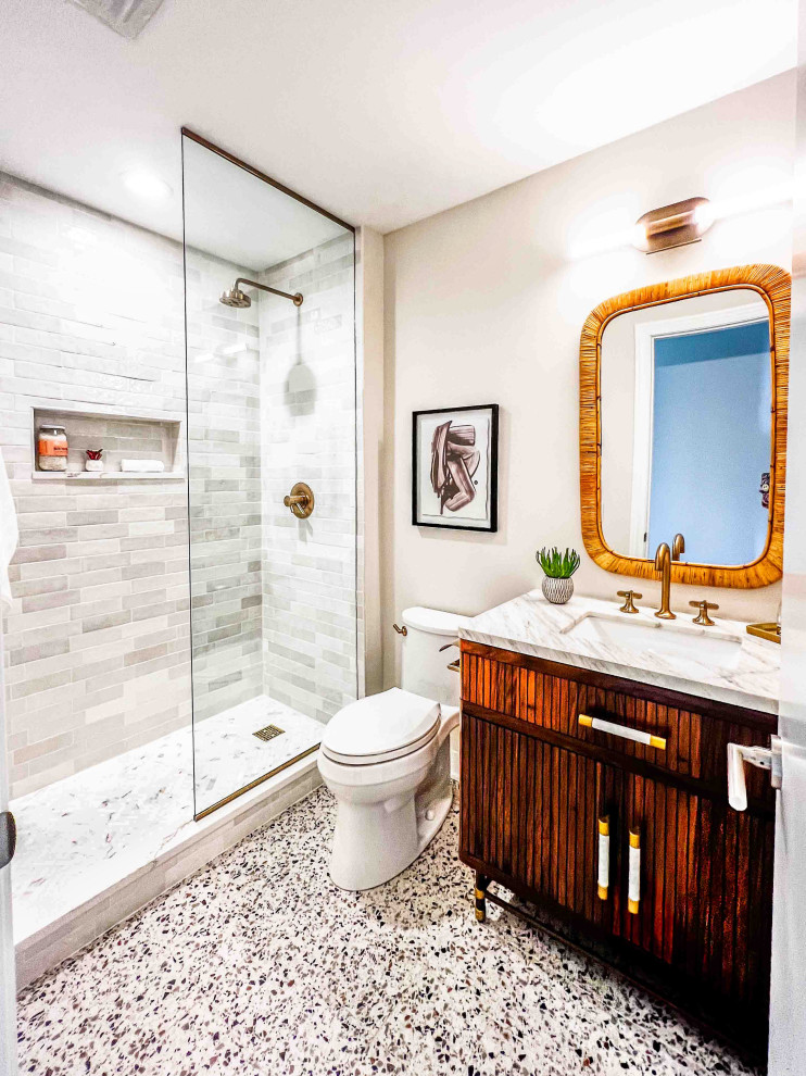 This is an example of a contemporary bathroom in Chicago with brown cabinets, a one-piece toilet, beige tile, ceramic tile, beige walls, porcelain floors, an undermount sink, engineered quartz benchtops, white floor, white benchtops, a freestanding vanity and flat-panel cabinets.
