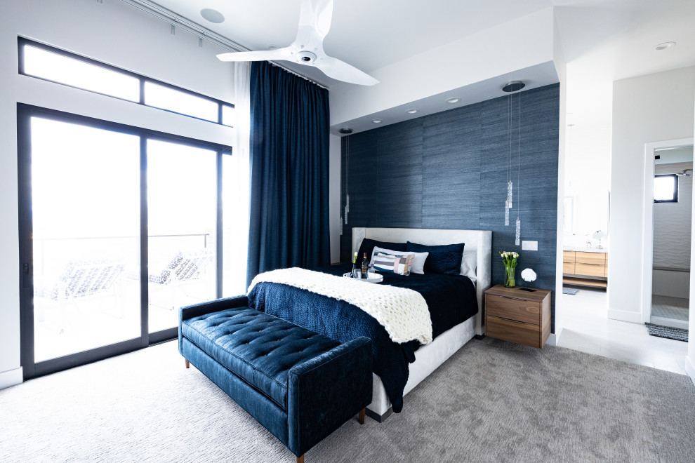 Imagen de dormitorio principal minimalista grande con paredes blancas, moqueta, todas las chimeneas, marco de chimenea de piedra, suelo marrón y papel pintado