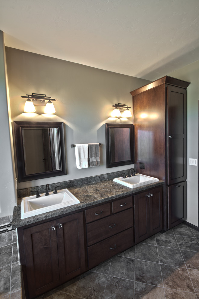 Design ideas for a mid-sized traditional master bathroom in Other with a drop-in sink, recessed-panel cabinets, dark wood cabinets, engineered quartz benchtops, a one-piece toilet, gray tile, glass tile, green walls and ceramic floors.