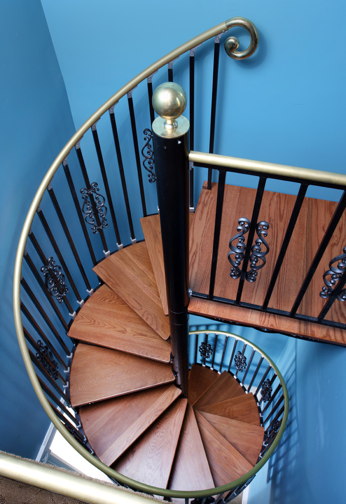 Photo of a medium sized victorian wood spiral staircase in Chicago with metal risers.