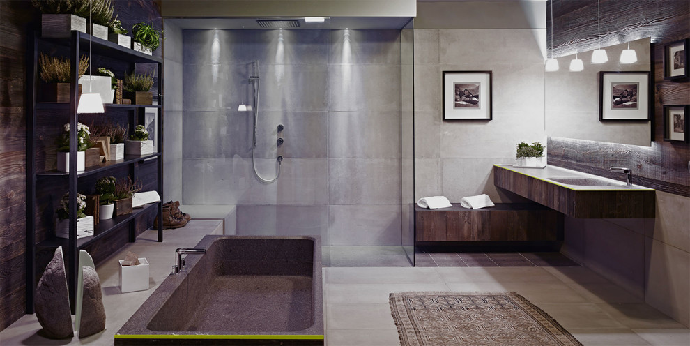 Design ideas for an industrial bathroom in Milan with an integrated sink, open cabinets, concrete benchtops, a freestanding tub, an open shower, gray tile, cement tile, grey walls, concrete floors and an open shower.