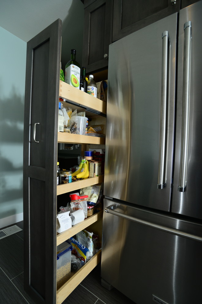 Eat-in kitchen - mid-sized transitional galley vinyl floor eat-in kitchen idea in Seattle with an undermount sink, shaker cabinets, white cabinets, quartz countertops, white backsplash, ceramic backsplash, stainless steel appliances and no island