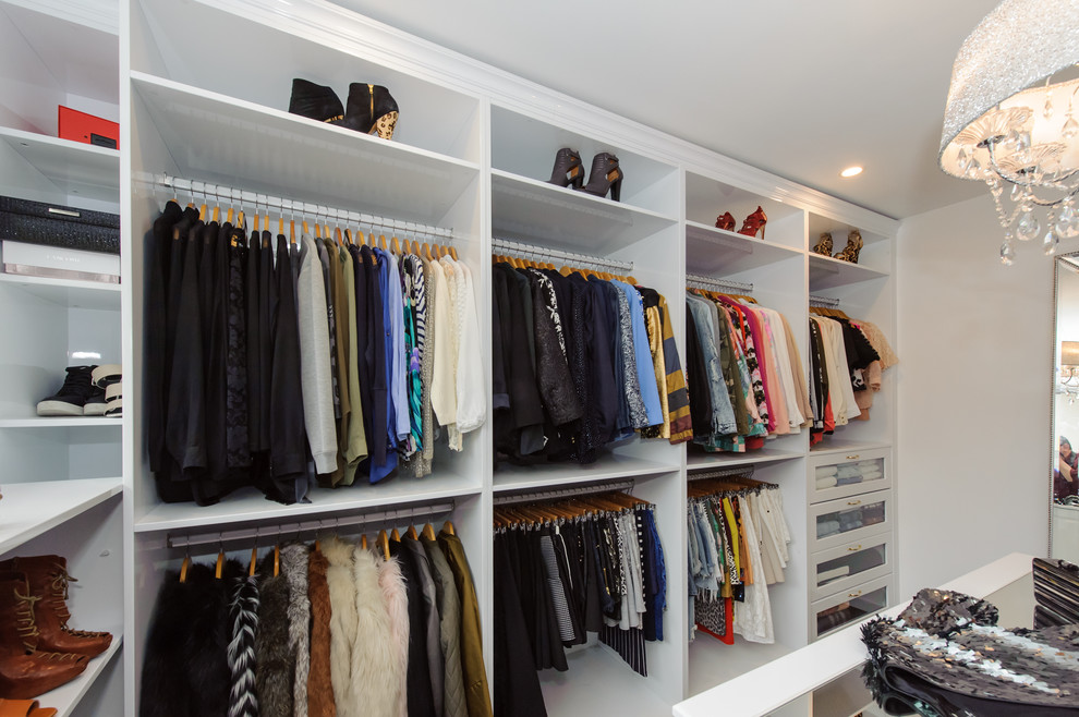 Photo of an expansive modern women's walk-in wardrobe in Sydney with dark hardwood floors, open cabinets and white cabinets.