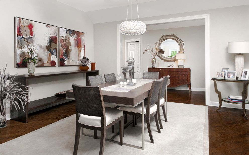 Design ideas for a transitional separate dining room in Chicago with grey walls and dark hardwood floors.