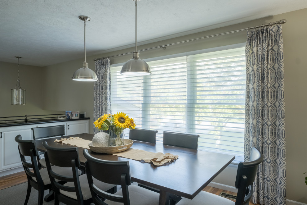 Example of a transitional brown floor dining room design in Grand Rapids with beige walls