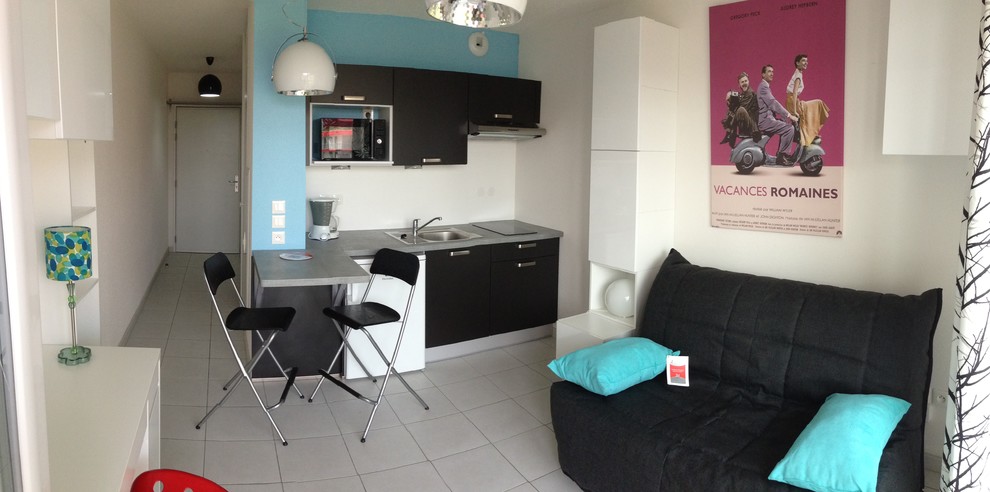 Photo of a small contemporary enclosed family room in Strasbourg with white walls, ceramic floors and grey floor.