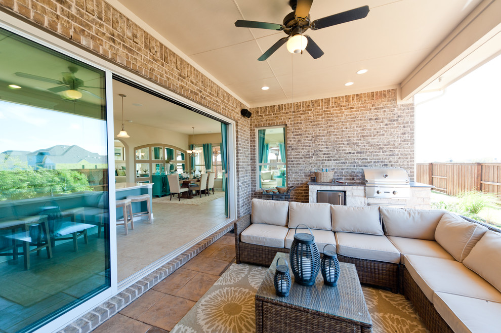 This is an example of a beach style backyard patio in Dallas with an outdoor kitchen.