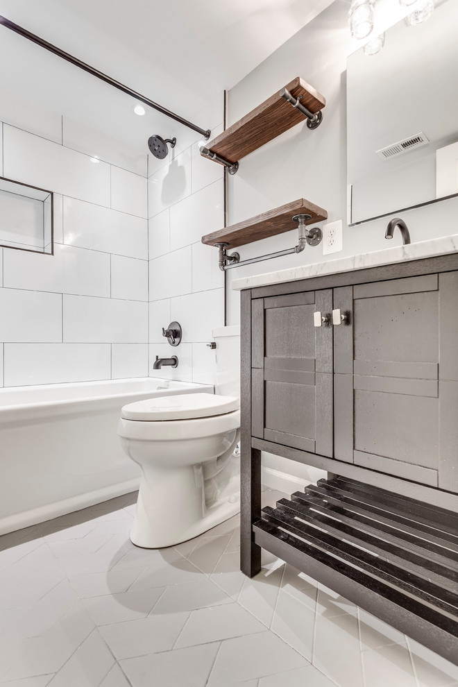 This is an example of a small transitional 3/4 bathroom in DC Metro with an alcove tub, a shower/bathtub combo, white tile, porcelain tile, an undermount sink, marble benchtops, a shower curtain, grey benchtops, dark wood cabinets, a two-piece toilet, grey walls, white floor and shaker cabinets.