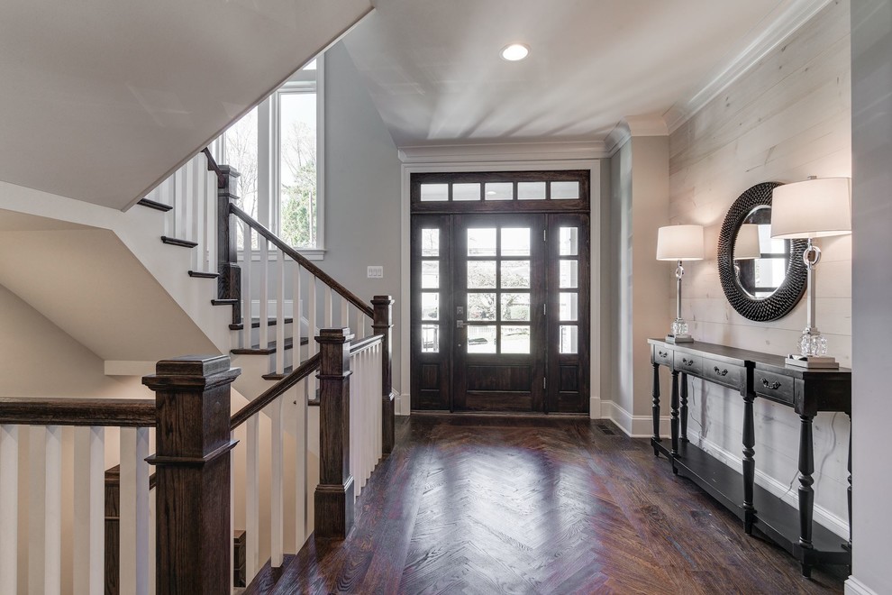 Large transitional medium tone wood floor and brown floor foyer photo in Baltimore with gray walls and a dark wood front door