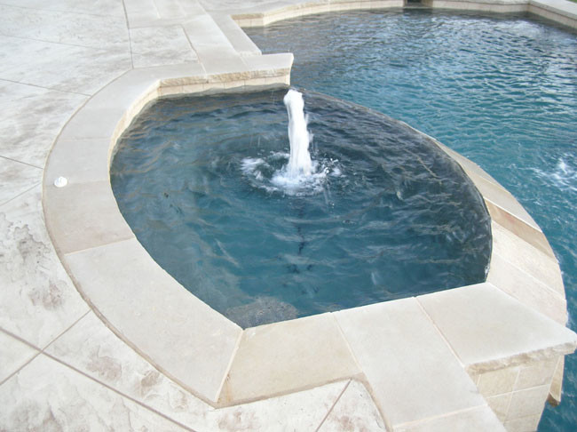 Photo of a mid-sized country backyard round infinity pool in Dallas with a hot tub and natural stone pavers.