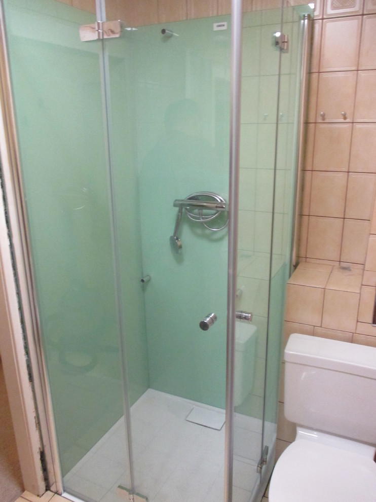 Imagen de cuarto de baño contemporáneo de tamaño medio con ducha a ras de suelo, baldosas y/o azulejos verdes, baldosas y/o azulejos de vidrio laminado y aseo y ducha
