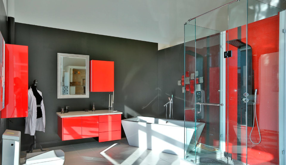 Design ideas for a mid-sized modern master bathroom in Toronto with flat-panel cabinets, red cabinets, engineered quartz benchtops, a freestanding tub, a corner shower, gray tile and grey walls.