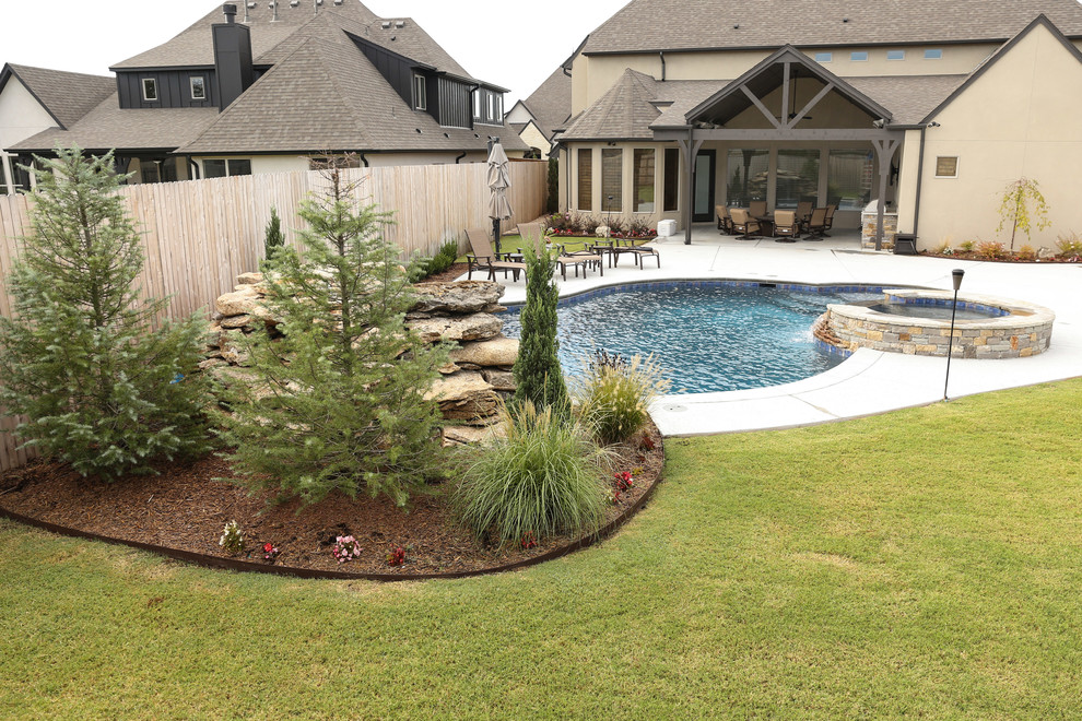 Large mountain style backyard concrete and custom-shaped lap hot tub photo