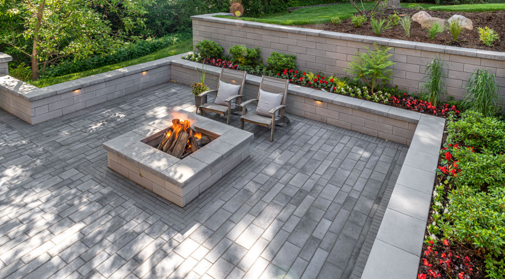 Contemporary backyard patio in Other with concrete pavers.