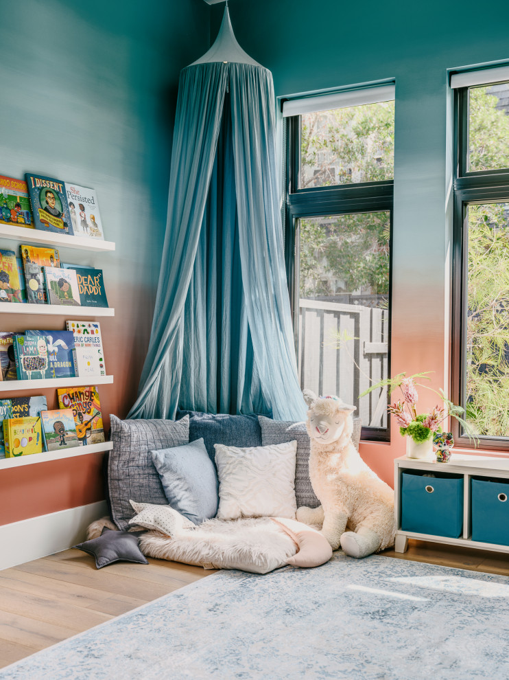 Inspiration för ett stort funkis flickrum kombinerat med sovrum, med flerfärgade väggar och ljust trägolv