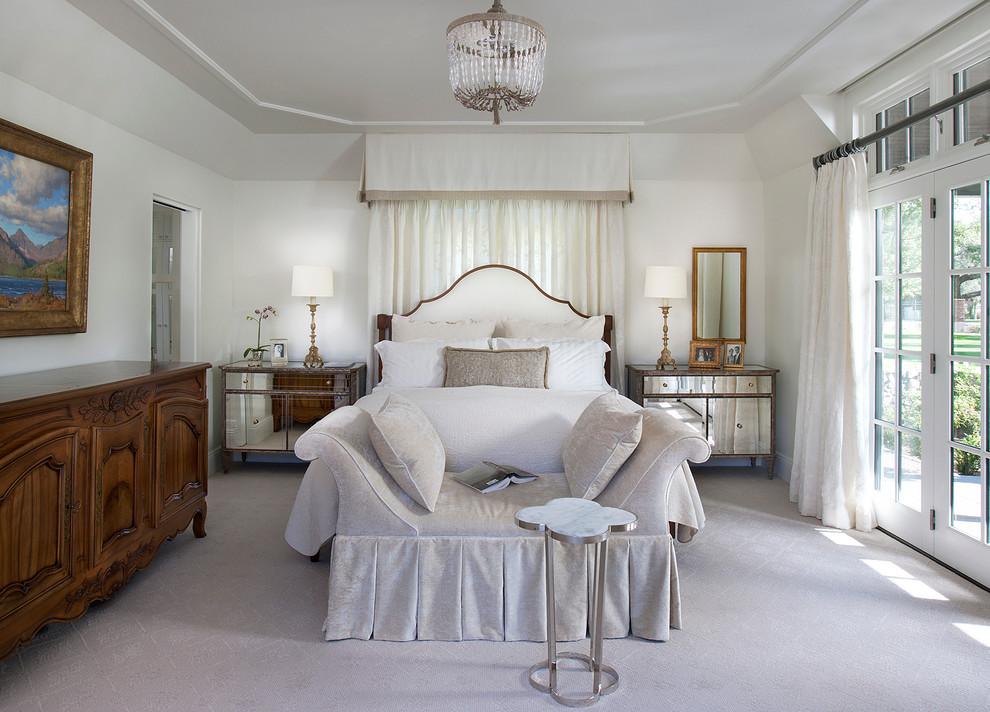 This is an example of a traditional bedroom in Phoenix with white walls and carpet.