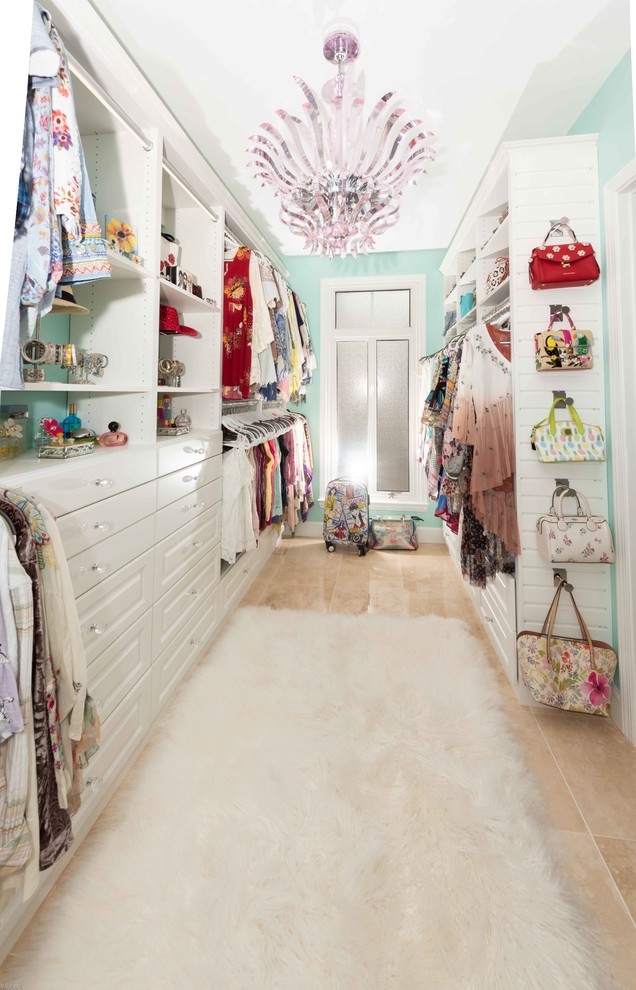 Inspiration for a large modern women's walk-in wardrobe in Other with raised-panel cabinets and white cabinets.
