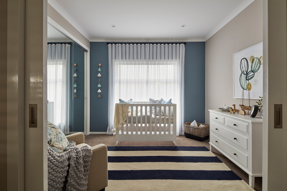 This is an example of a beach style gender-neutral nursery in Other with beige walls, carpet and beige floor.
