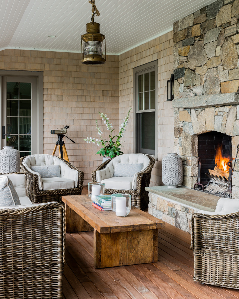 Inspiration for a coastal porch remodel in Boston with a fireplace, decking and a roof extension