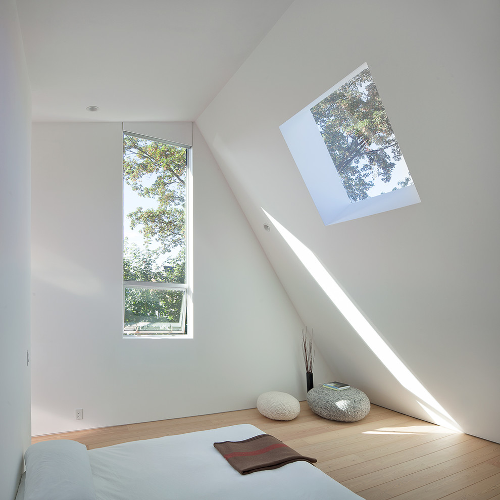 Inspiration for a mid-sized modern master bedroom in Vancouver with white walls and medium hardwood floors.