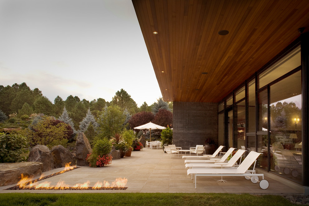Design ideas for a modern patio in Denver with a fire feature.