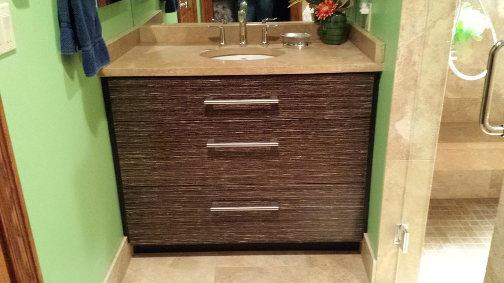 Small eclectic 3/4 beige tile and stone tile travertine floor home design photo with an undermount sink, brown cabinets, limestone countertops, a wall-mount toilet and green walls