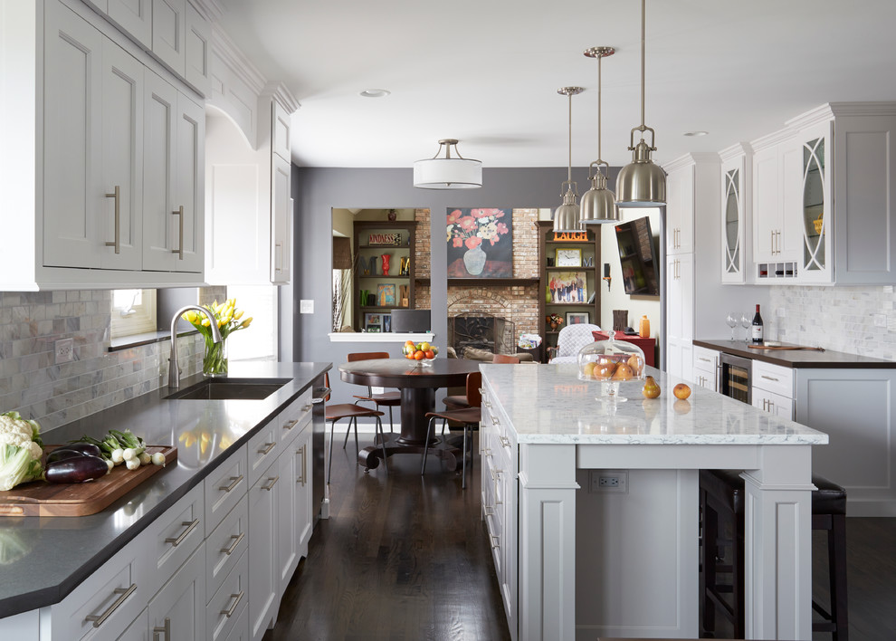 Example of a large transitional dark wood floor eat-in kitchen design in Chicago with a single-bowl sink, shaker cabinets, white cabinets, quartz countertops, white backsplash, stone tile backsplash, stainless steel appliances and two islands