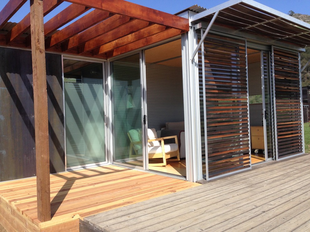 This is an example of a small modern enclosed living room in San Luis Obispo with light hardwood floors.