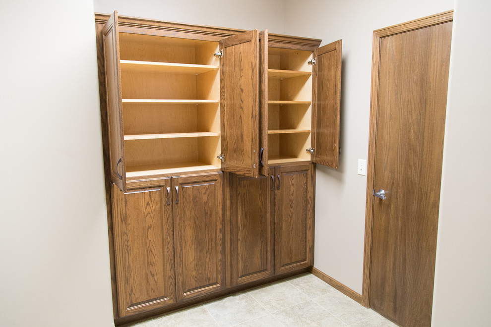 Photo of a mid-sized arts and crafts dressing room in Wichita with open cabinets, light wood cabinets, ceramic floors and grey floor.