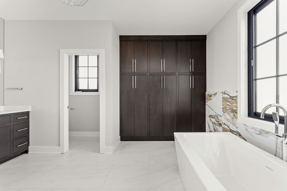 This is an example of a mid-sized modern master bathroom in Indianapolis with flat-panel cabinets, dark wood cabinets, a freestanding tub, a curbless shower, a two-piece toilet, beige tile, porcelain tile, white walls, ceramic floors, an undermount sink, white floor, a hinged shower door, white benchtops, a shower seat, a double vanity and a built-in vanity.