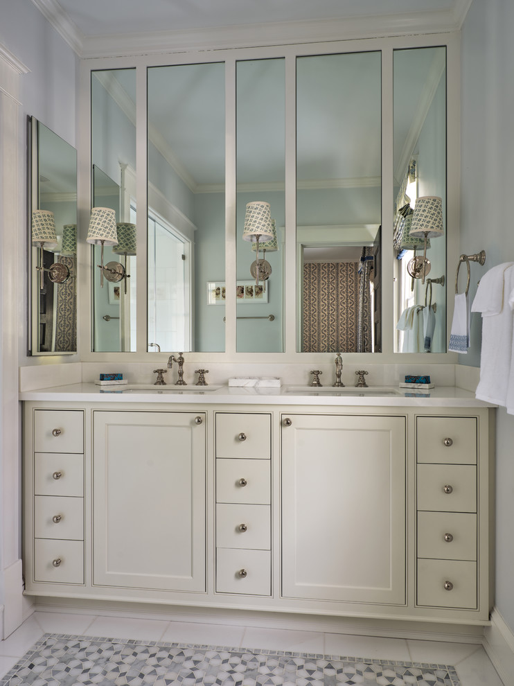 Inspiration for a traditional bathroom in DC Metro with recessed-panel cabinets, beige cabinets, white walls, mosaic tile floors, an undermount sink, multi-coloured floor and white benchtops.