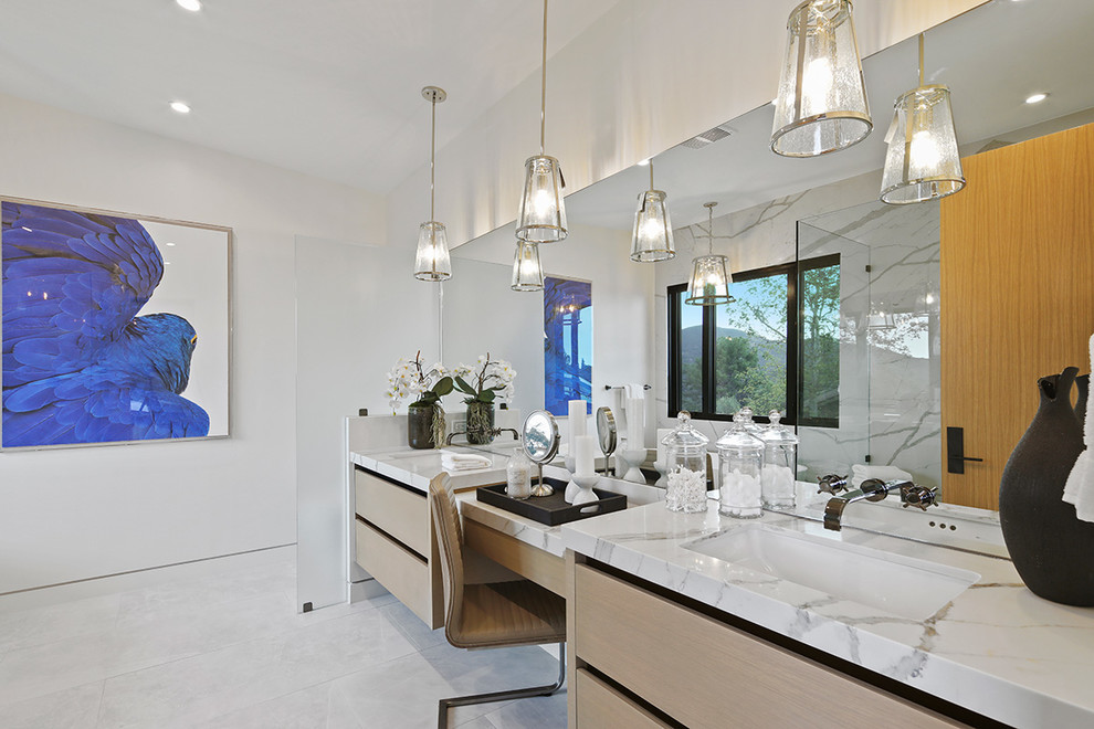 Photo of a large modern master bathroom in Los Angeles with gray tile, flat-panel cabinets, light wood cabinets, a freestanding tub, an open shower, marble, white walls, marble floors, an undermount sink, marble benchtops, white floor, a hinged shower door, white benchtops, a double vanity and a built-in vanity.