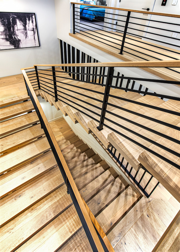 Inspiration for a large beach style wood u-shaped staircase in Seattle with metal railing.