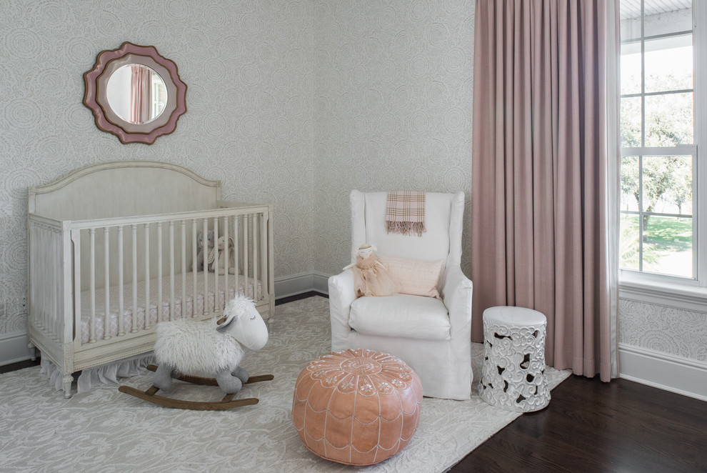 Photo of a traditional nursery for girls in Tampa with grey walls and dark hardwood floors.